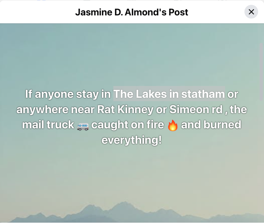 A social media post from Jasmine D. Almond reporting a fire on a mail truck near Rat Kinney or Simeon Road in The Lakes area of Statham. The background shows a pale sky and mountain silhouettes.