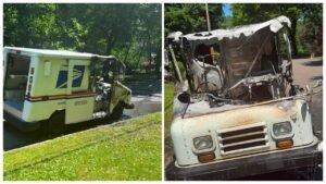 A damaged United States Postal Service truck shows significant fire damage. The rear of the vehicle is intact, while the front is heavily charred with a melted hood and burnt interior. The setting includes lush green grass and a street lined with trees.