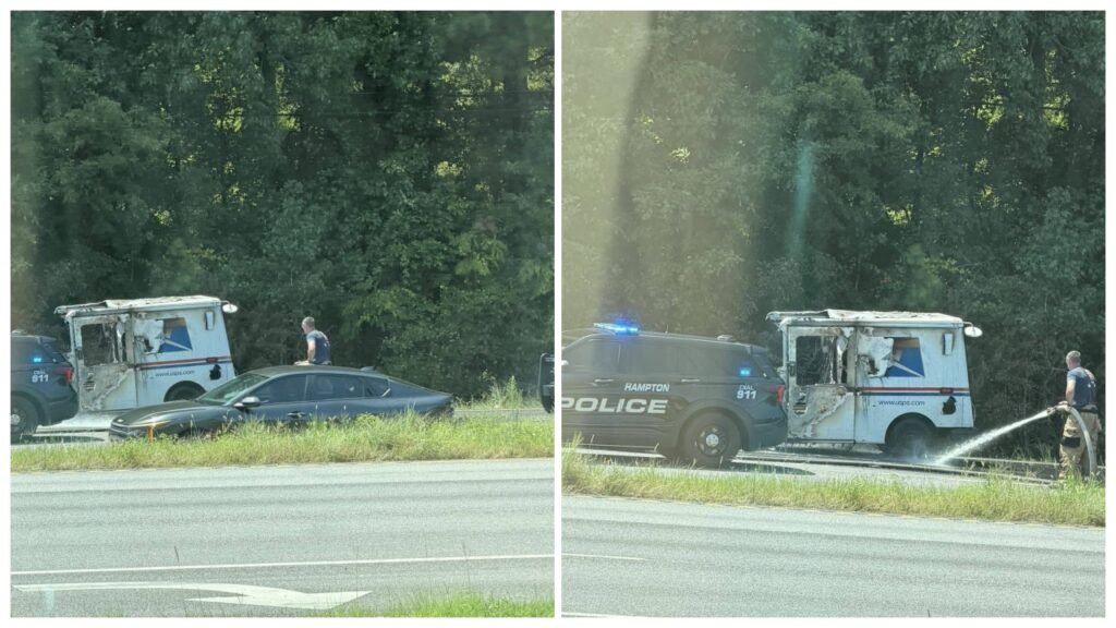 A damaged white delivery van and a black police SUV are stopped beside a highway, with a person spraying water near the van and trees in the background.